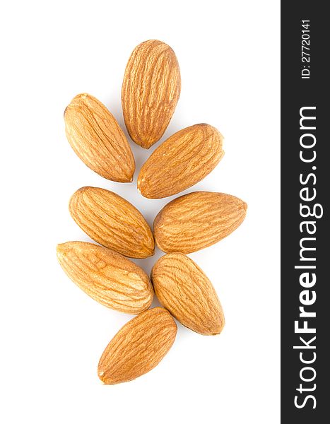 Few almonds on a white background isolated. Few almonds on a white background isolated