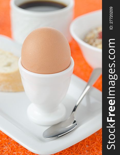 Boiled egg for breakfast, cereal and coffee in the background. Boiled egg for breakfast, cereal and coffee in the background