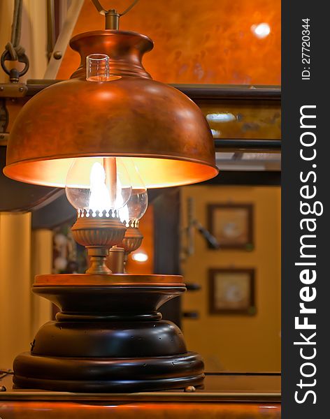 Old kerosene lamp with copper shade