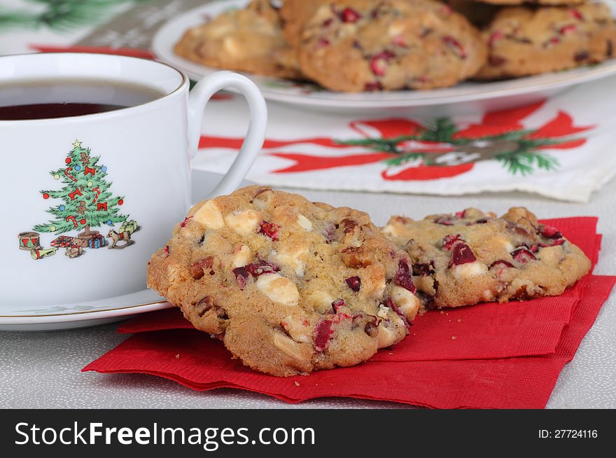 Two cranberry and nut cookies on a napkin with cup of coffee. Two cranberry and nut cookies on a napkin with cup of coffee