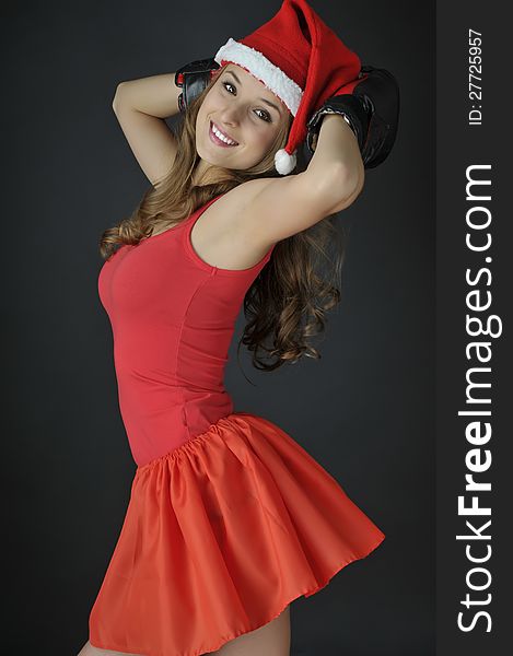 Christmas funny girl wearing boxing gloves. Christmas funny girl wearing boxing gloves