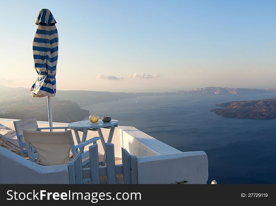 White table overlooking the sea, Santorini, Greece