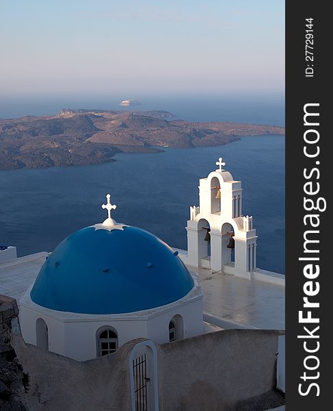 Church of the island of Santorini against the bright sky and sea