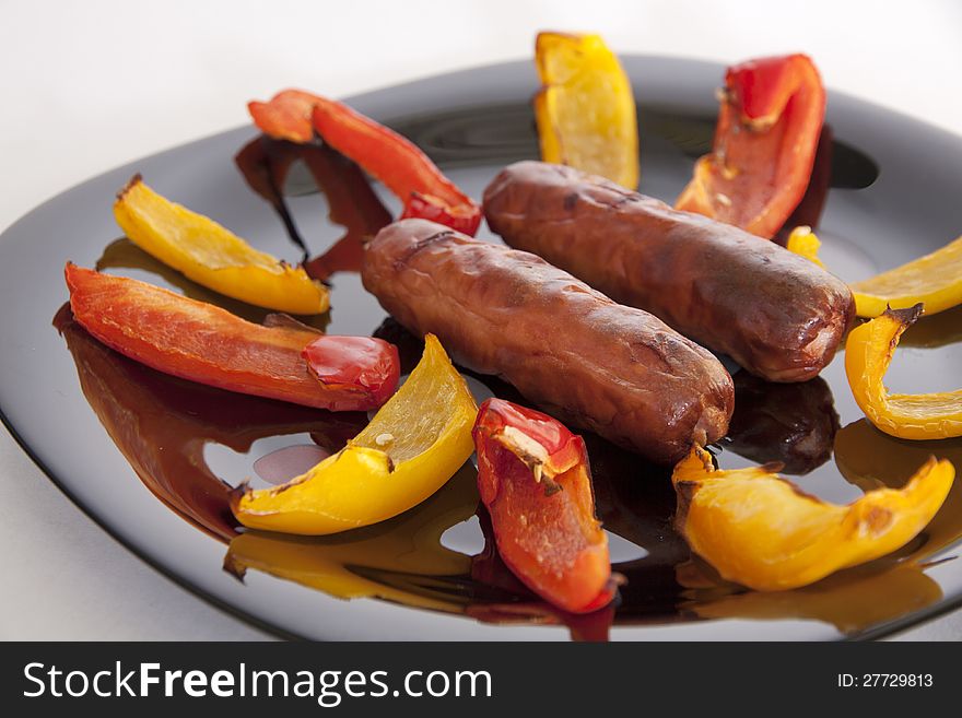 Grilled sausages and colorful peppers