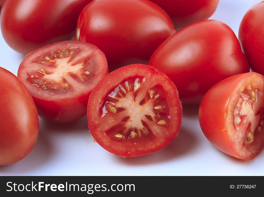 Group of sliced and whole tomatoes