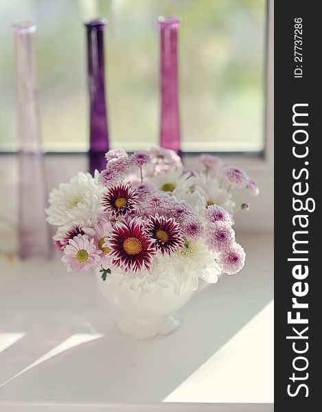 Beautiful delicate bouquet of pink chrysanthemums in a blue bucket. Beautiful delicate bouquet of pink chrysanthemums in a blue bucket