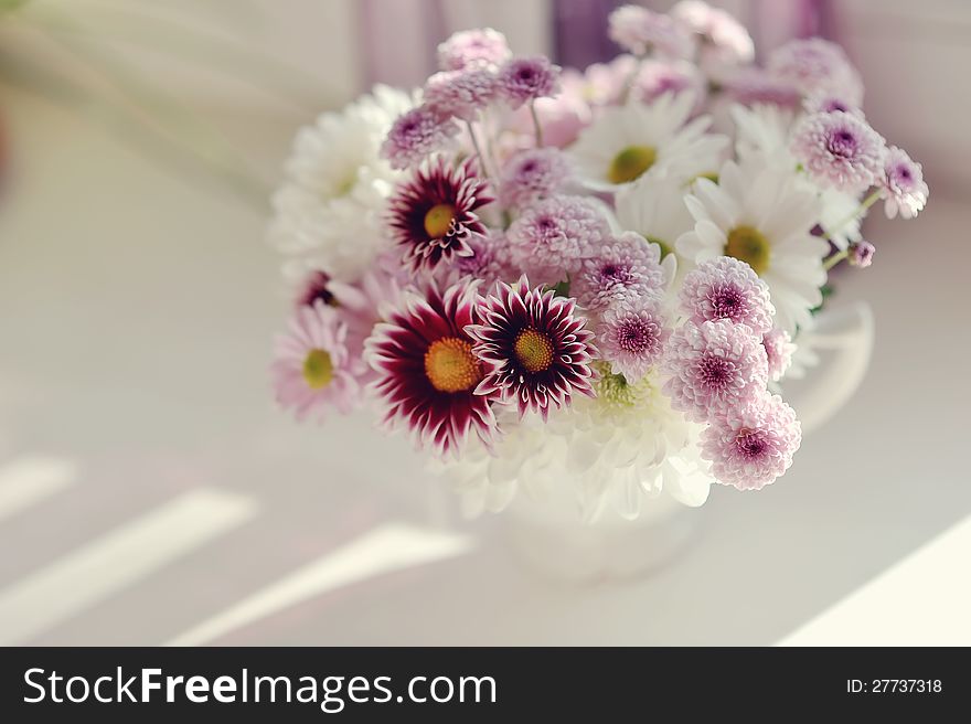 Beautiful delicate bouquet of pink chrysanthemums in a blue bucket. Beautiful delicate bouquet of pink chrysanthemums in a blue bucket