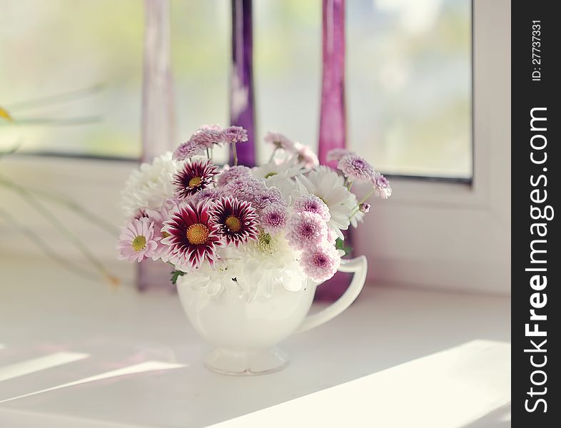 Beautiful delicate bouquet of pink chrysanthemums in a blue bucket. Beautiful delicate bouquet of pink chrysanthemums in a blue bucket