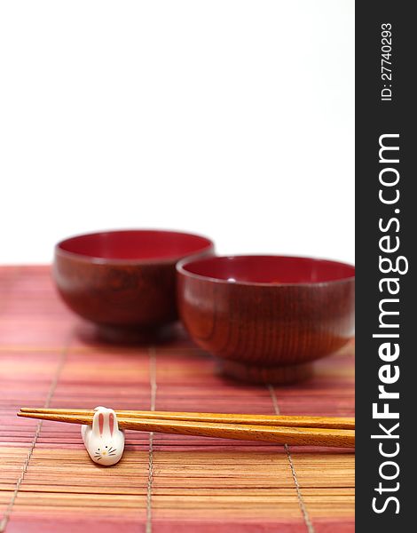 Chopsticks in asian set table on white background