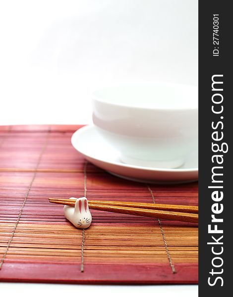 Chopsticks in asian set table on white background
