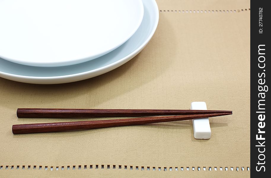 Chopsticks in asian set table on white background