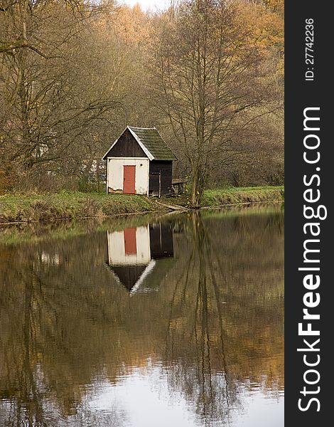 House reflecting on water in autumn, nove mesto nad metuji