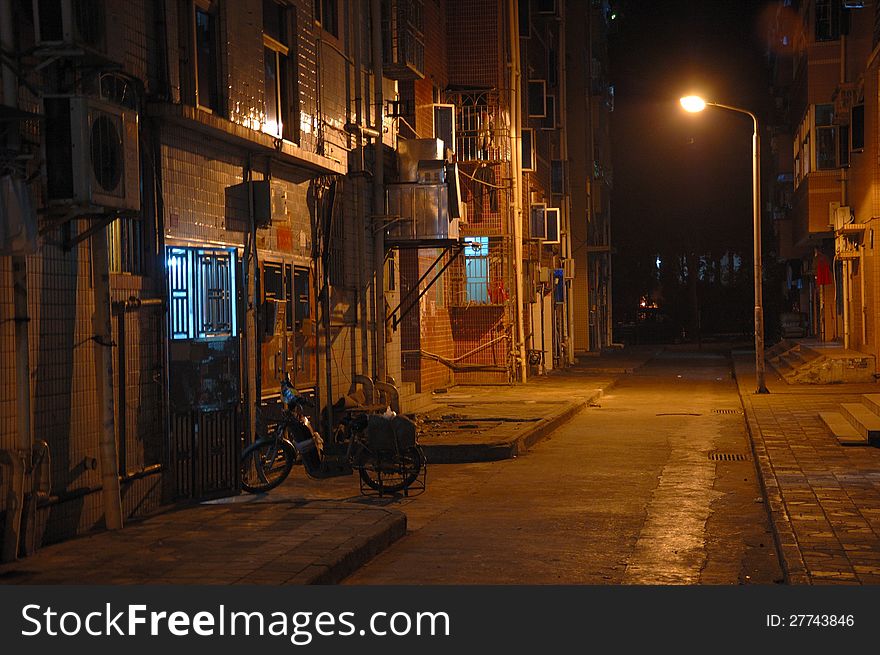 Empty street and tenement house by night in Chinese city. Empty street and tenement house by night in Chinese city.
