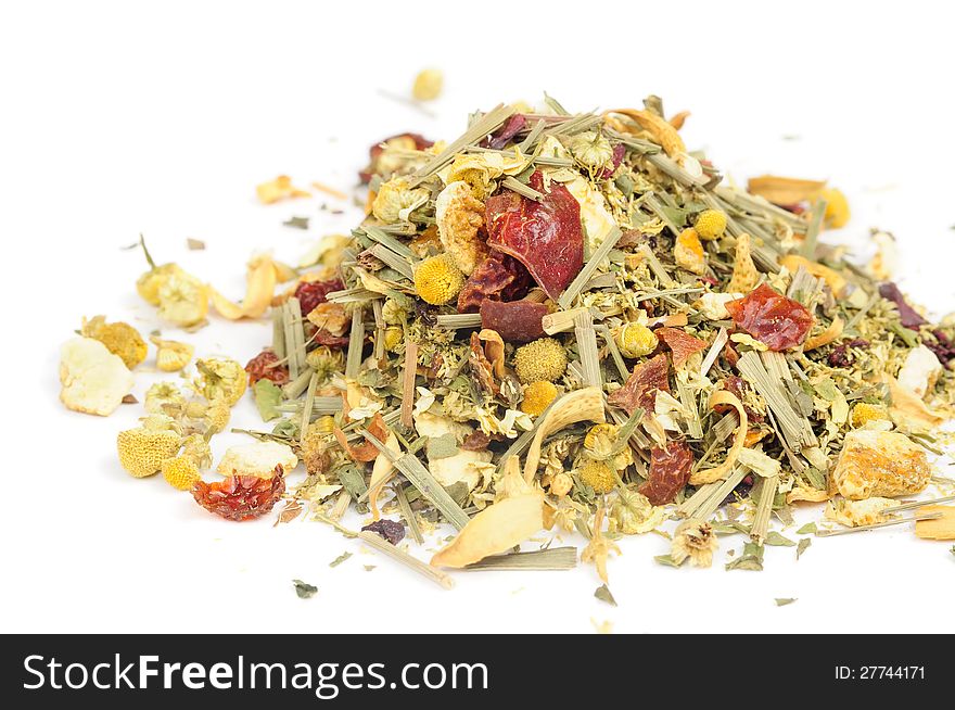 A pile of herbal tea with chamomile, lemongrass and citrus peels on a white background. A pile of herbal tea with chamomile, lemongrass and citrus peels on a white background