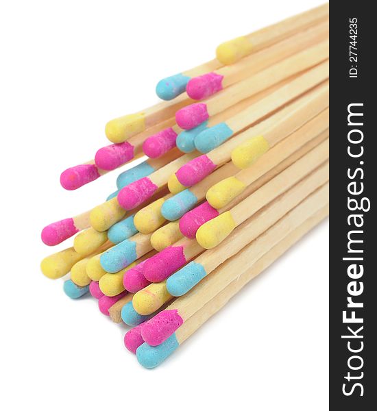 A bunch of multicolored matches on a white background. A bunch of multicolored matches on a white background