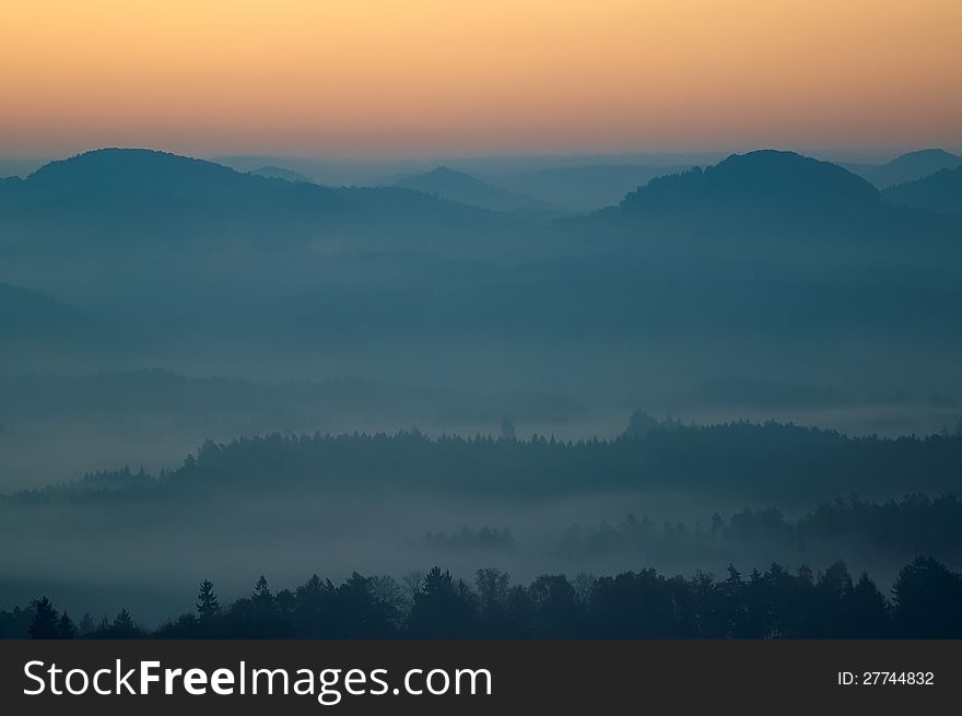 Autumn morning hilly landscape with fog