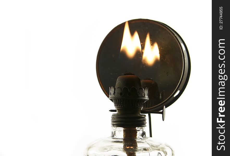 Old oil lamp with flame isolated on white background