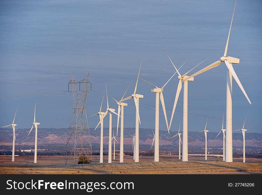 Aligned windmills for renowable electric production and power line, Pozuelo de Aragon, Zaragoza, Aragon, Spain