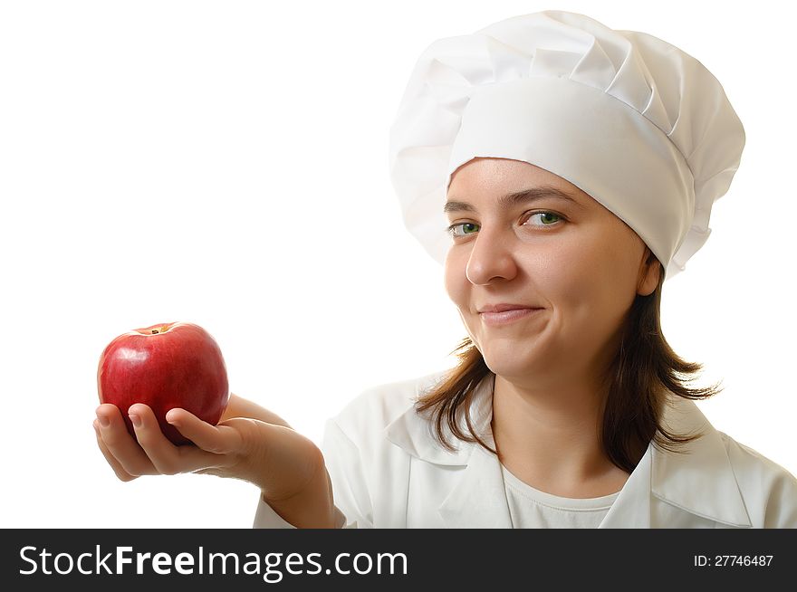 Happy cook woman holding an apple on white background. Happy cook woman holding an apple on white background