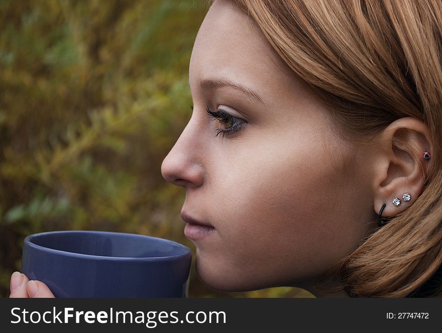 Portrait of a woman with cup, outdoors. Portrait of a woman with cup, outdoors