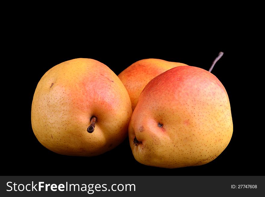 Yellow-red pears isolated on black