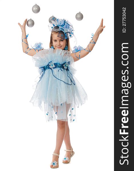 Full-length portrait of a beautiful little girl in a smart dress and accessories posing in the studio on a white background and flying balls. Full-length portrait of a beautiful little girl in a smart dress and accessories posing in the studio on a white background and flying balls