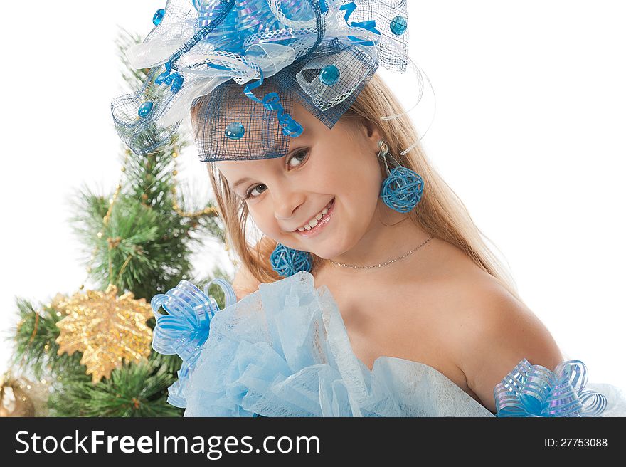 Portrait of a cute little girl in a beautiful dress and ornaments for the head against the Christmas tree. Portrait of a cute little girl in a beautiful dress and ornaments for the head against the Christmas tree