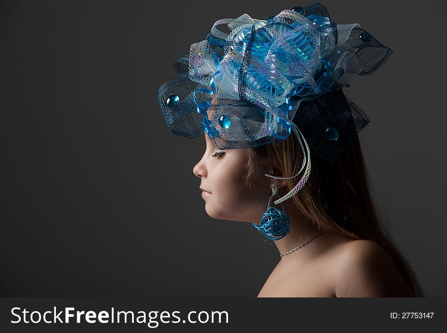 Close-up portrait of a pretty girl  in the decoration of elegant headdress posing in the studio. Close-up portrait of a pretty girl  in the decoration of elegant headdress posing in the studio