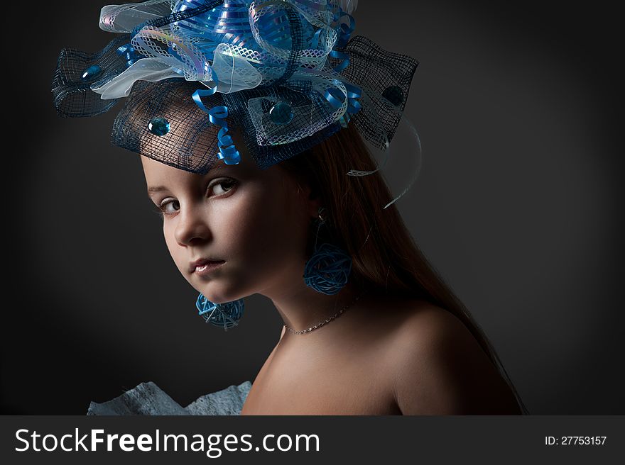 Close-up portrait of a pretty girl in the decoration of elegant headdress posing in the studio. Close-up portrait of a pretty girl in the decoration of elegant headdress posing in the studio