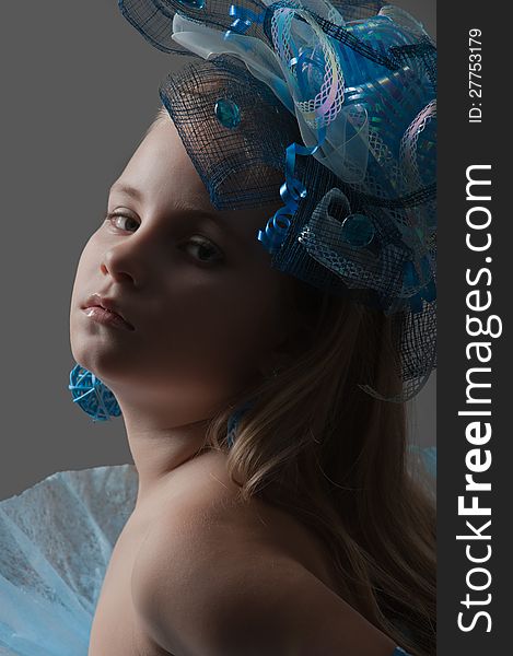 Close-up portrait of a pretty girl  in the decoration of elegant headdress posing in the studio. Close-up portrait of a pretty girl  in the decoration of elegant headdress posing in the studio