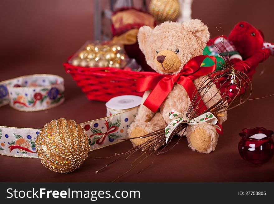 Christmas  teddy with basket for gifts on brown background with red ribbon. Christmas  teddy with basket for gifts on brown background with red ribbon