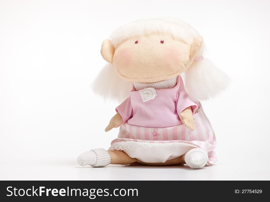 Handmade toy cute litlle girl on the white. Handmade toy cute litlle girl on the white