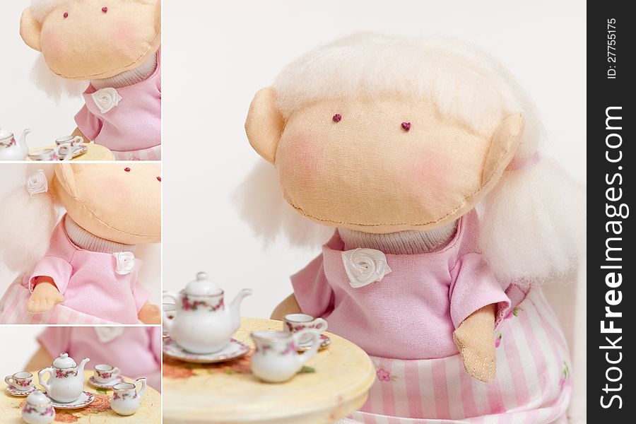 Handmade toy cute litlle girl having a tea. Handmade toy cute litlle girl having a tea