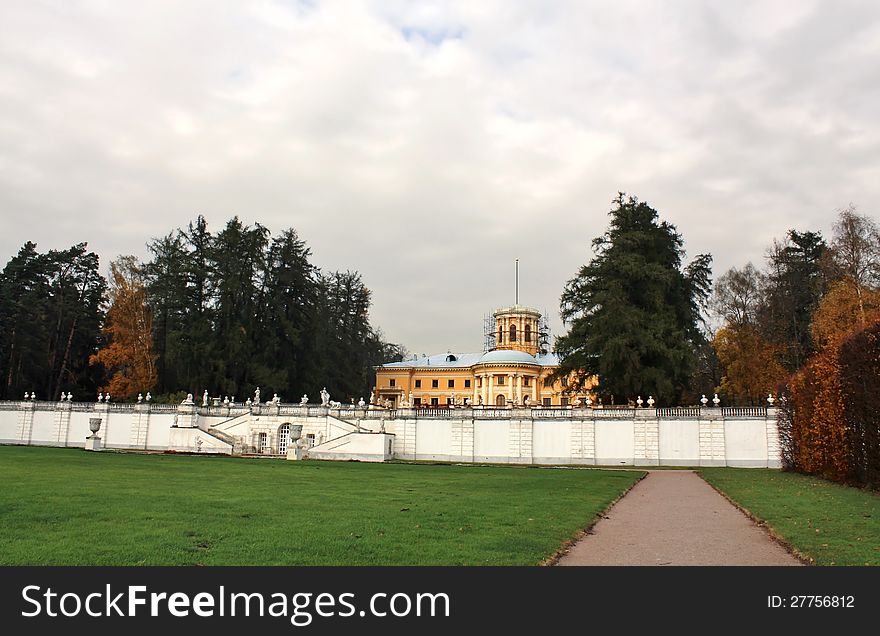 Eighteenth-century mansion with sculptural group of classical terrace on the background of trees. Eighteenth-century mansion with sculptural group of classical terrace on the background of trees