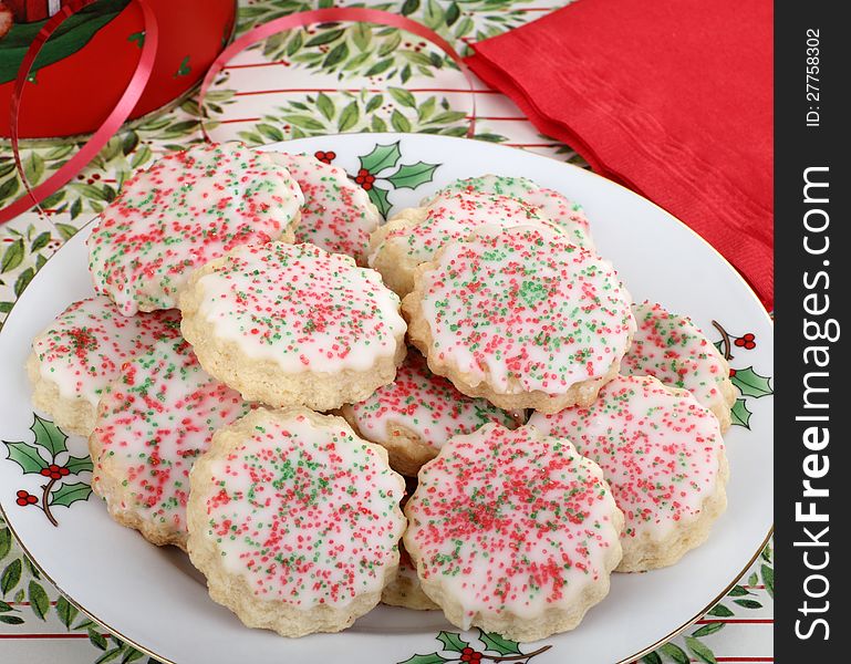 Plate of shortbread Christmas cookies with icing and colored sprinkles. Plate of shortbread Christmas cookies with icing and colored sprinkles