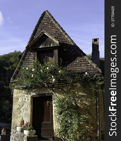 An old cottage-style house at Beynac in the Perigord area of France. These little house are often used as bed-and-breakfast places as the Dordogne area is very popular with tourists. An old cottage-style house at Beynac in the Perigord area of France. These little house are often used as bed-and-breakfast places as the Dordogne area is very popular with tourists.