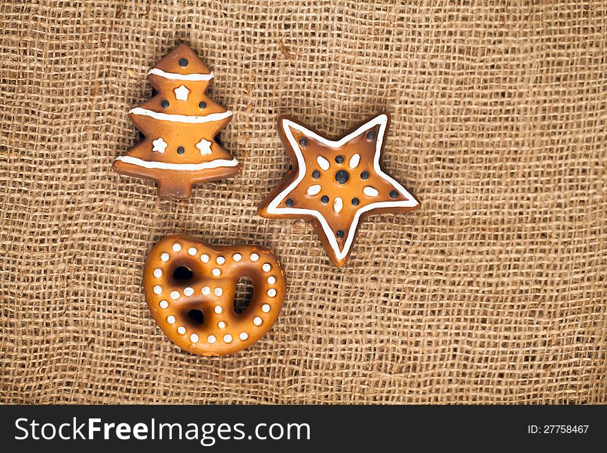 Three shapes of ginger bread cake, german lebkuchen on burlap background. Three shapes of ginger bread cake, german lebkuchen on burlap background