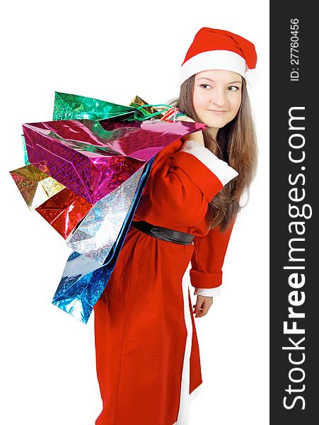 Cute young girl dressed as Santa brings gifts isolated. Cute young girl dressed as Santa brings gifts isolated