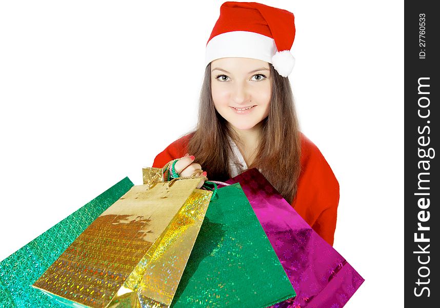 Cute teen girl dressed as Santa with presents isolated