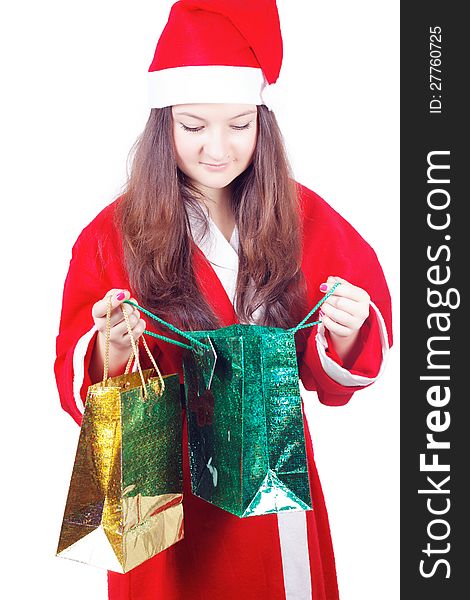 Pretty teen girl dressed as Santa looks gifts isolated