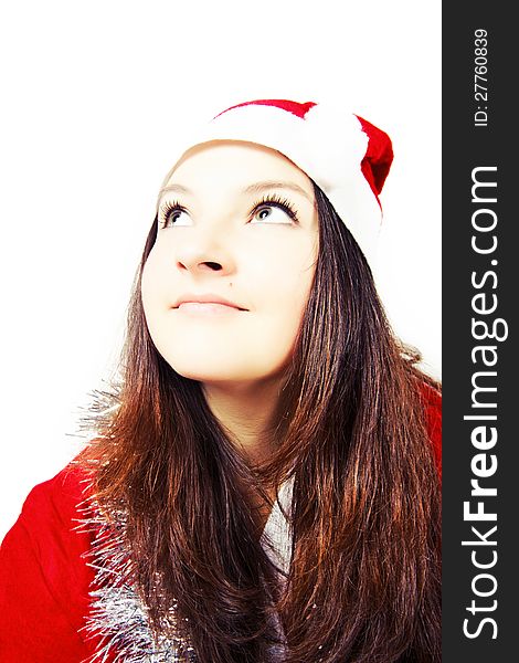 Portrait of a pretty young girl dressed as Santa isolated
