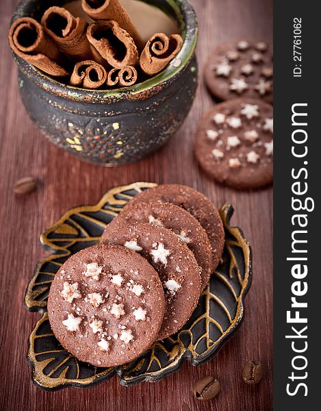 Chocolate chip cookies and cinnamon sticks in an old pot. Chocolate chip cookies and cinnamon sticks in an old pot