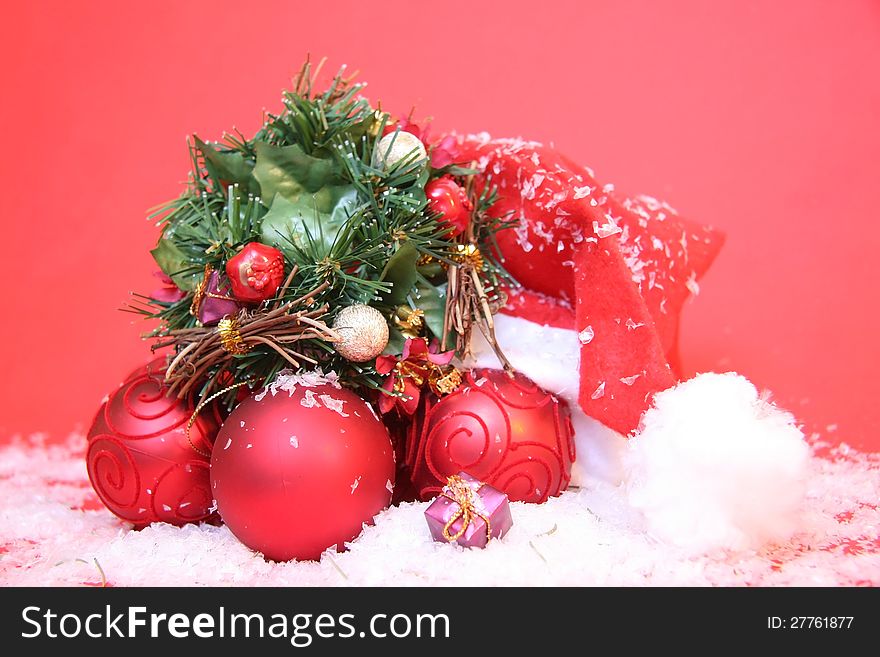 Santa Claus hat with tree ornaments on a red background. Santa Claus hat with tree ornaments on a red background