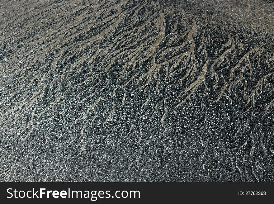 Abstract patterned background with black and gray sand of coastal India. Abstract patterned background with black and gray sand of coastal India