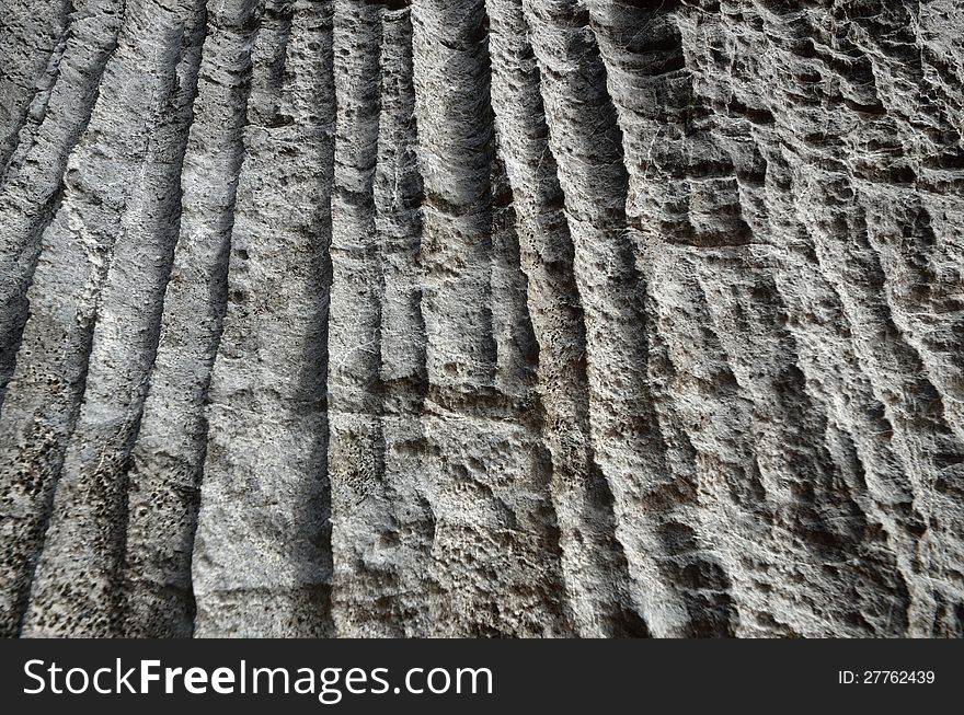 Texture of gray rock with vertical stripes. Texture of gray rock with vertical stripes