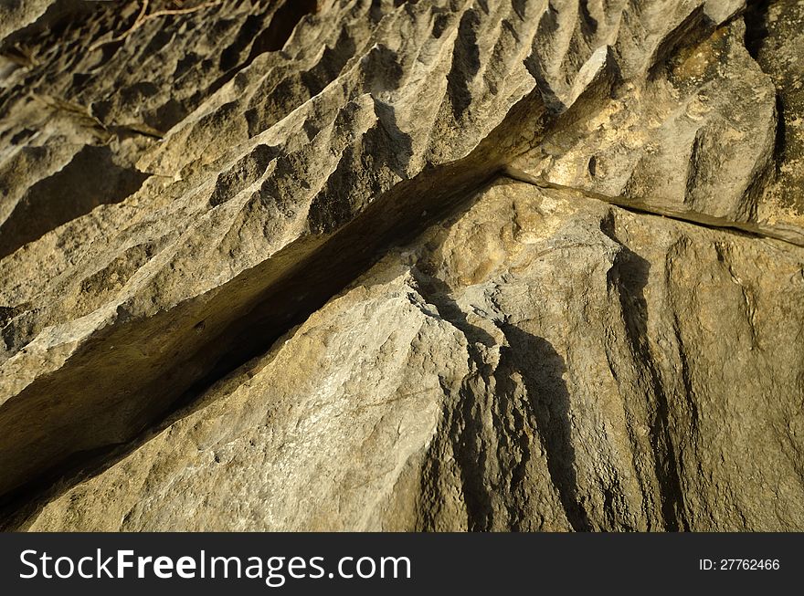 An interesting abstract gray-yellow stone cliffs. An interesting abstract gray-yellow stone cliffs