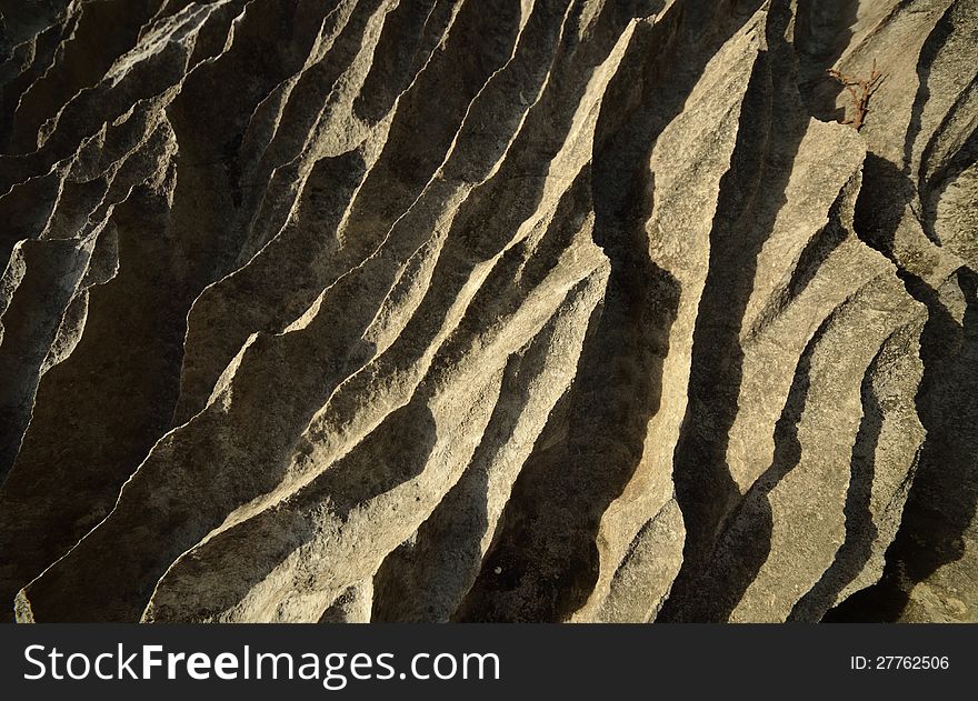 An interesting abstract gray-yellow stone cliffs. An interesting abstract gray-yellow stone cliffs