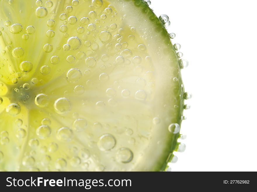 Lime slice in water bubbles. Lime slice in water bubbles