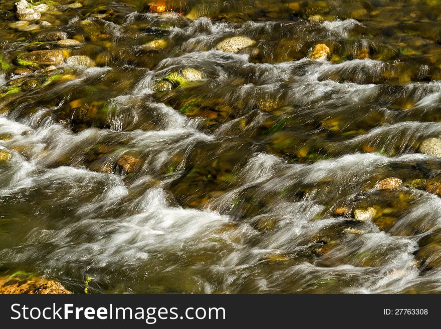 Beautiful veil cascading waterfall, mossy rocks. Beautiful veil cascading waterfall, mossy rocks