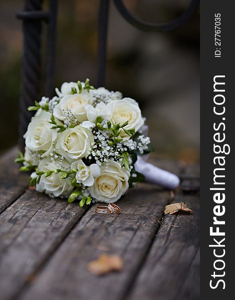 Wedding Rings And White Rose Bouquet